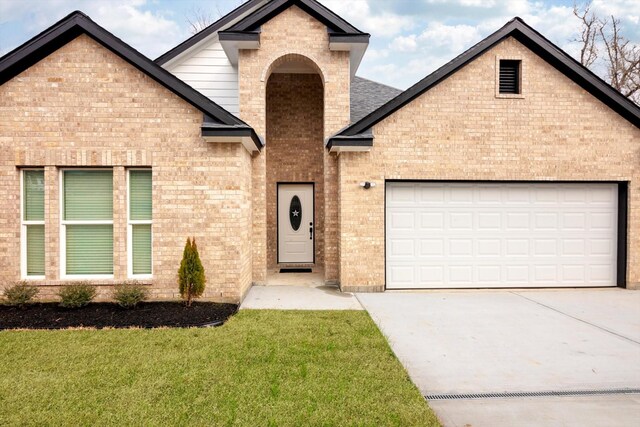 113 County Road 645, Kenefick, TX 77535 - view of front facade with a garage and a front lawn