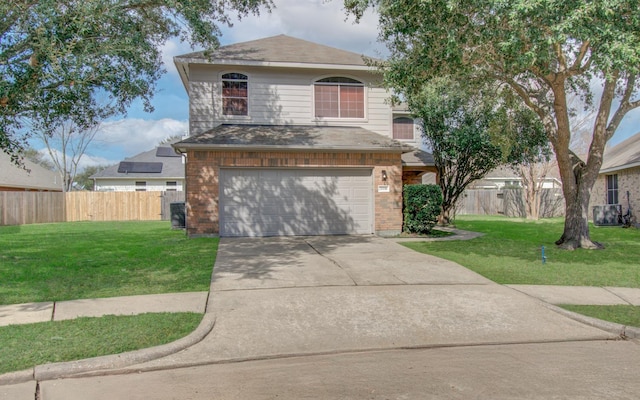 view of property featuring a garage, central air condition unit, and a front lawn