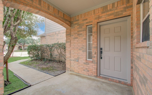 property entrance with brick siding