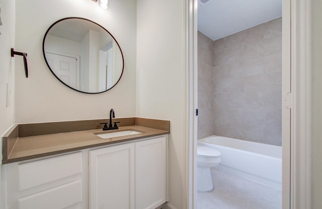 full bathroom featuring tiled shower / bath, vanity, and toilet