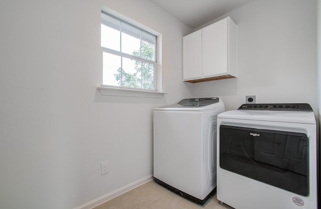 laundry area with cabinets and washer and clothes dryer