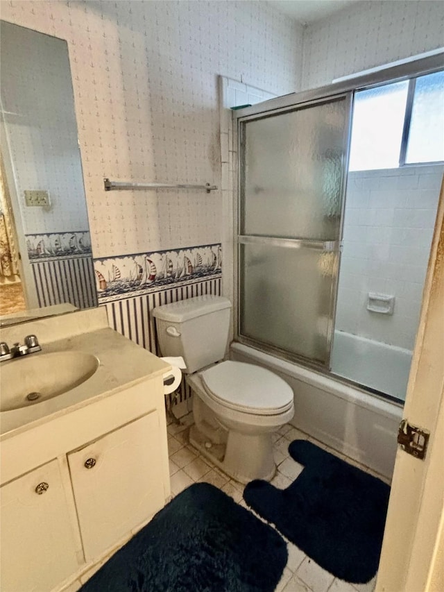 full bathroom with enclosed tub / shower combo, tile patterned floors, toilet, and vanity