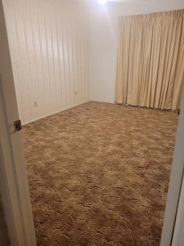 empty room featuring dark carpet