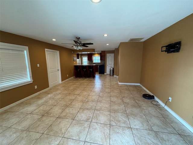 unfurnished living room with ceiling fan and light tile patterned floors