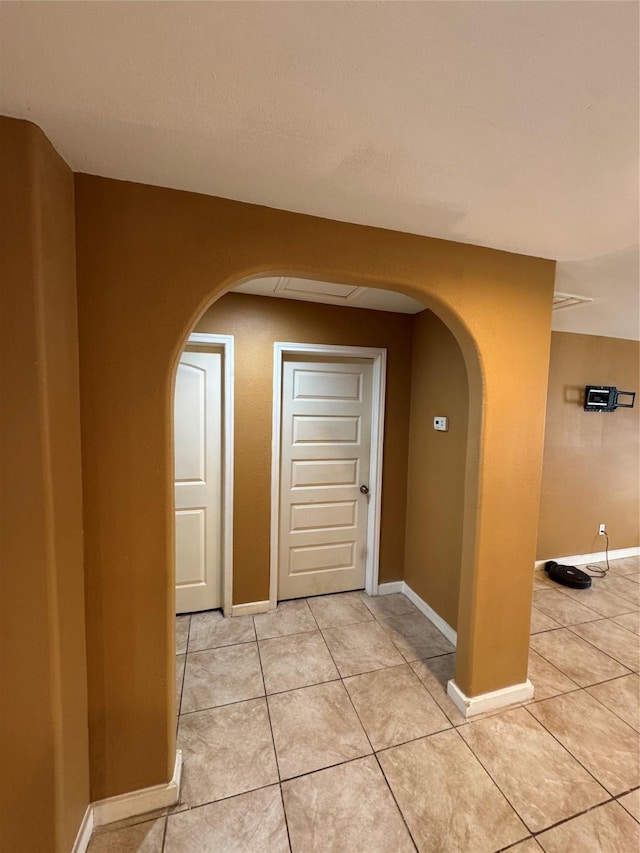 hall with light tile patterned floors