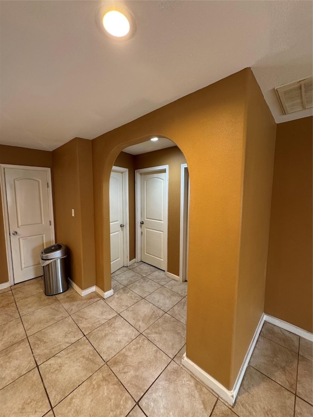 corridor featuring light tile patterned floors