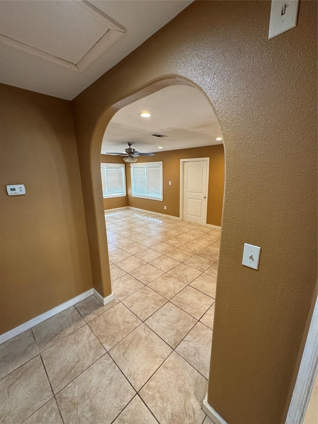 corridor featuring light tile patterned floors