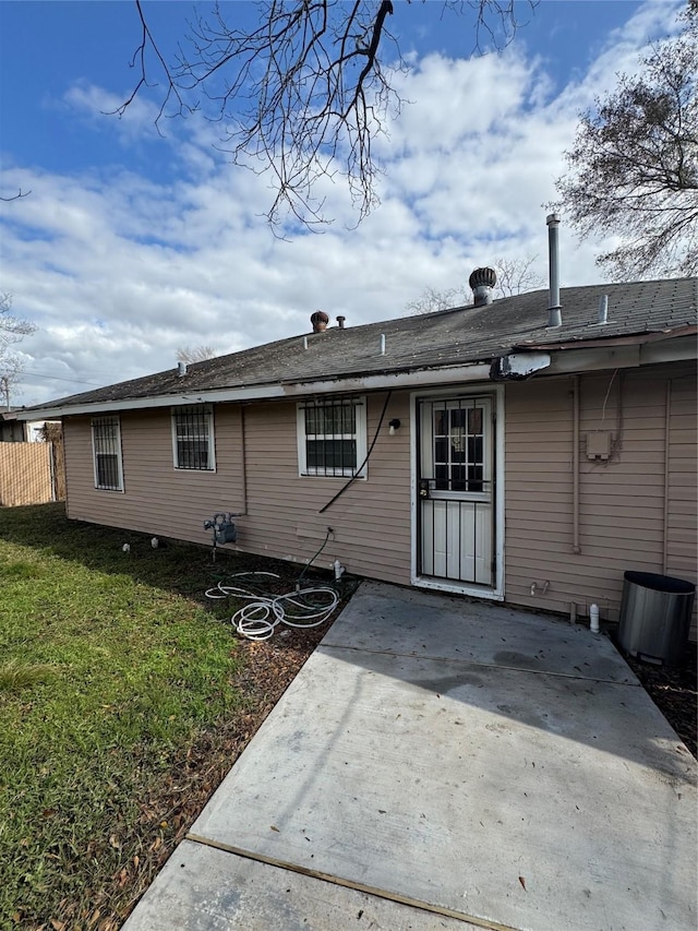 back of house featuring a yard and a patio area