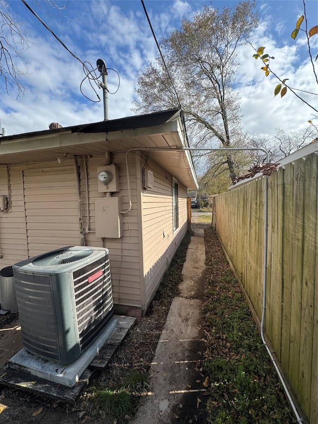 view of side of home featuring central AC