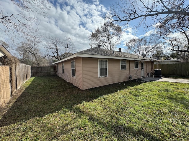 back of house with a patio, a yard, and central AC unit