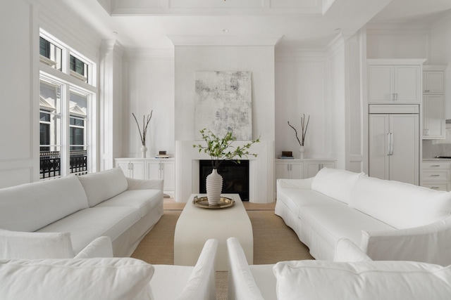 living room with a fireplace and ornamental molding