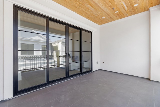 tiled spare room featuring wood ceiling