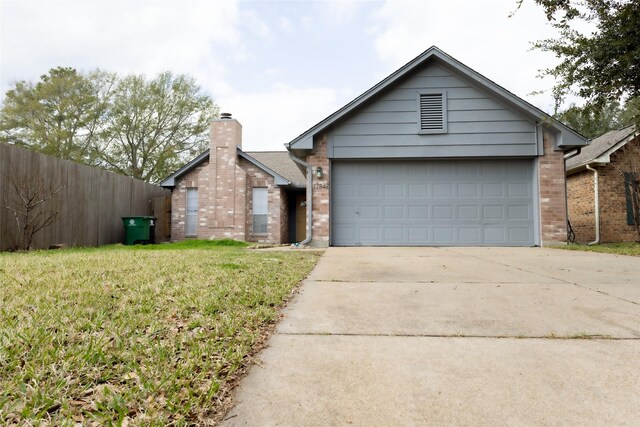 view of front of home with a garage and a front yard