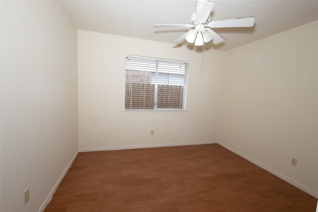 empty room with baseboards, a ceiling fan, and wood finished floors