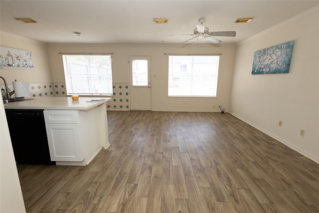 kitchen with visible vents, black dishwasher, wood finished floors, white cabinetry, and light countertops