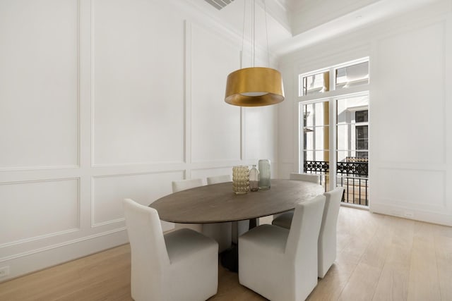 dining space with light hardwood / wood-style flooring