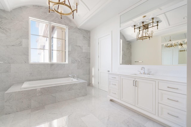 bathroom featuring a relaxing tiled tub, a notable chandelier, vanity, and vaulted ceiling