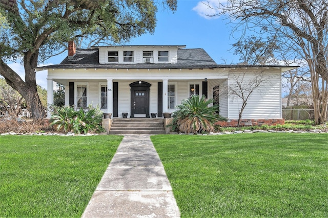 bungalow-style home with a front lawn and covered porch