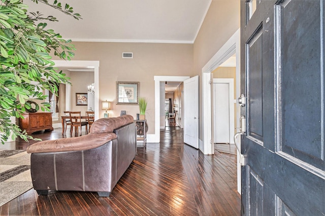 living room featuring ornamental molding and dark hardwood / wood-style flooring