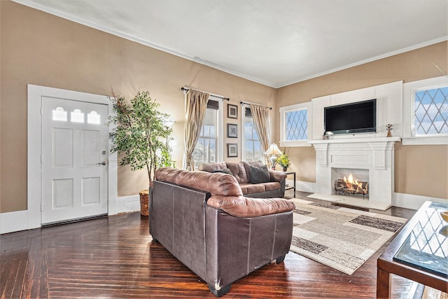 living room with dark wood-type flooring, ornamental molding, and a healthy amount of sunlight