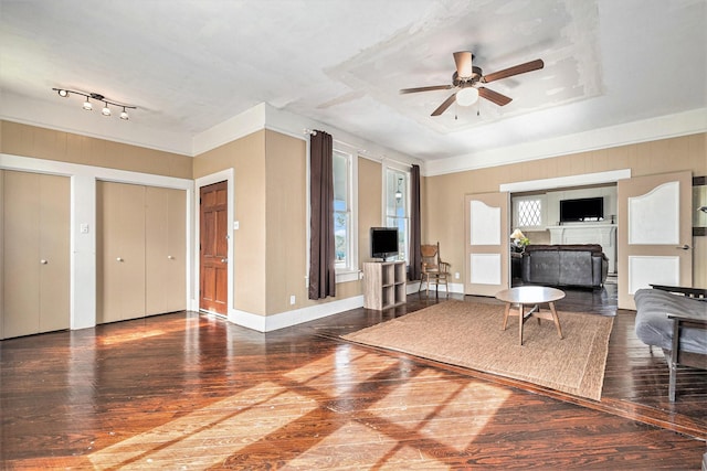 unfurnished living room featuring wood-type flooring and ceiling fan