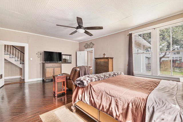 bedroom with ornamental molding, dark hardwood / wood-style floors, and ceiling fan