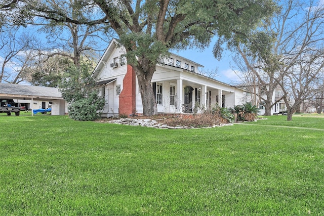 view of side of home with a yard