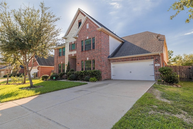 view of front property featuring a garage and a front yard