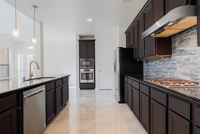 kitchen with pendant lighting, tasteful backsplash, sink, stainless steel appliances, and french doors