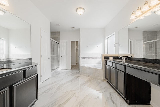 bathroom featuring vanity and separate shower and tub