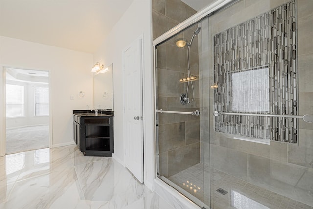 bathroom featuring walk in shower and vanity