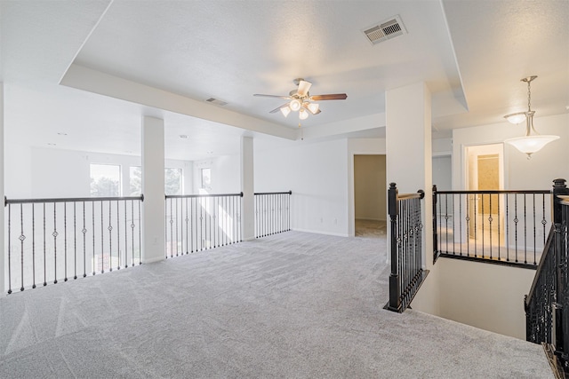 carpeted empty room featuring ceiling fan