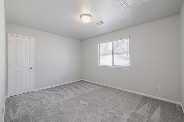 carpeted empty room with a textured ceiling