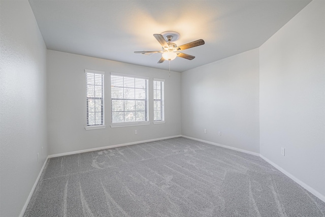 carpeted empty room featuring ceiling fan