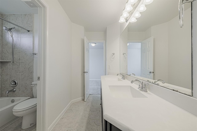 full bathroom with tiled shower / bath combo, vanity, and toilet