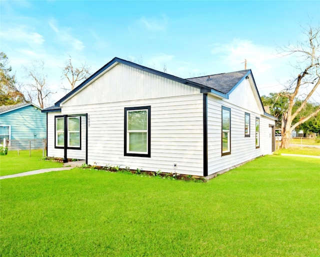 view of side of property with a lawn