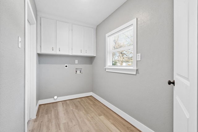 laundry area with cabinets, washer hookup, hookup for an electric dryer, and light hardwood / wood-style flooring