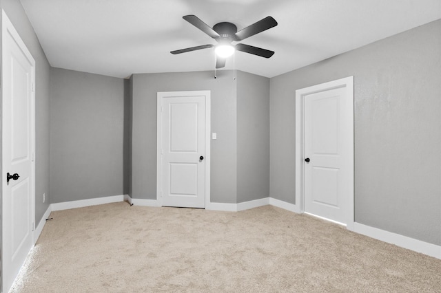 unfurnished bedroom featuring ceiling fan and light colored carpet