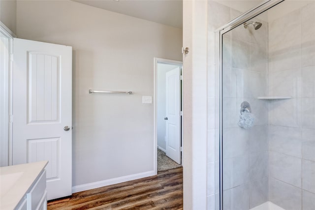 bathroom with vanity, hardwood / wood-style floors, and a shower with shower door