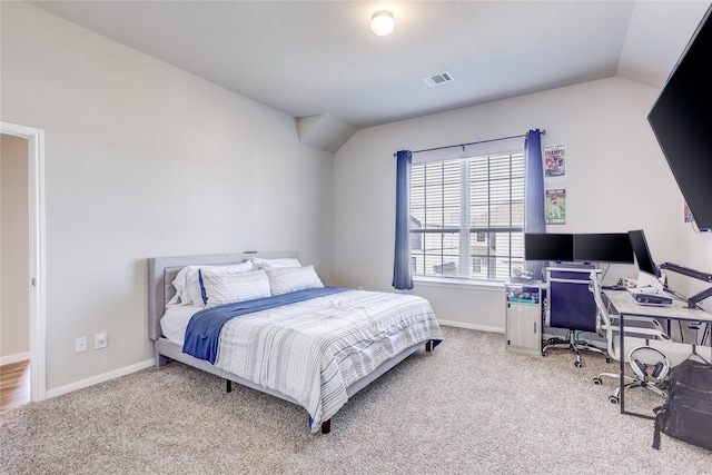 bedroom featuring lofted ceiling and light colored carpet