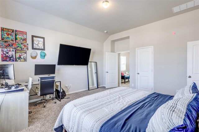 bedroom featuring vaulted ceiling and light colored carpet