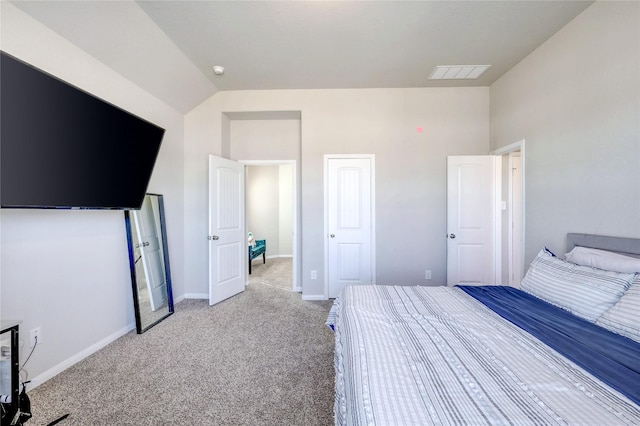 unfurnished bedroom with vaulted ceiling and light carpet