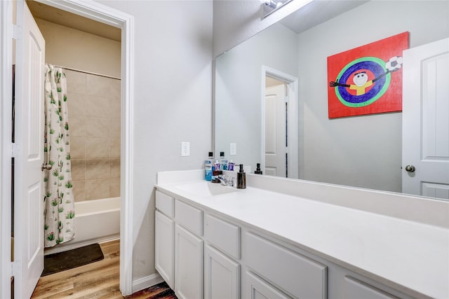 bathroom with vanity, hardwood / wood-style flooring, and shower / bath combo