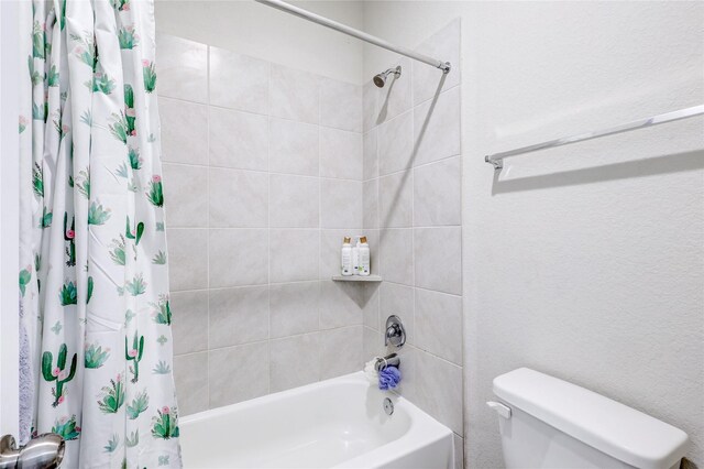 bathroom with shower / tub combo and toilet