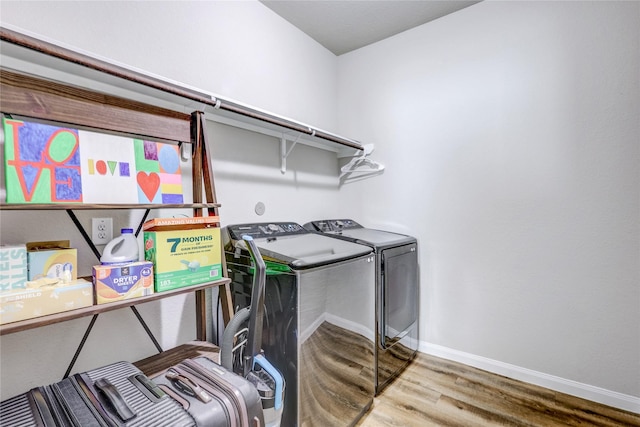 washroom featuring hardwood / wood-style floors and washer and clothes dryer