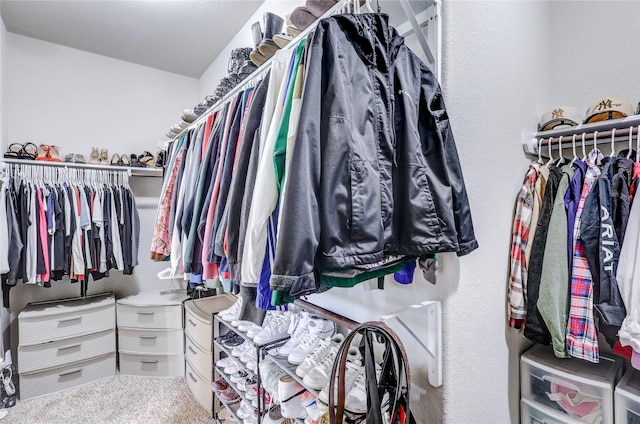 walk in closet with carpet flooring