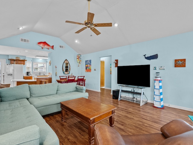 living room featuring lofted ceiling, wood-type flooring, and ceiling fan