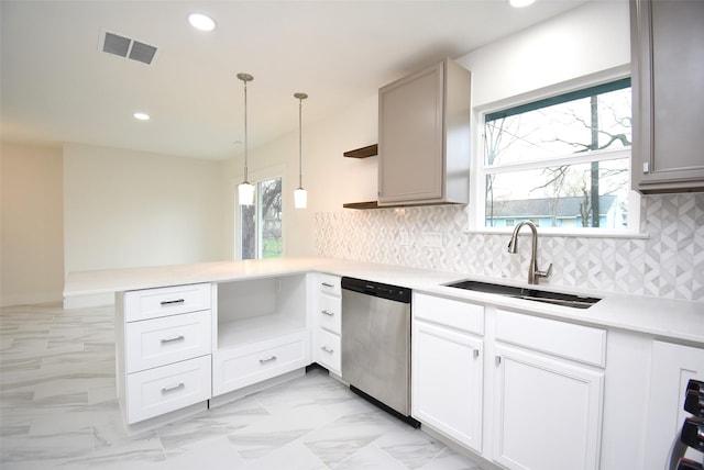 kitchen featuring sink, hanging light fixtures, dishwasher, kitchen peninsula, and a healthy amount of sunlight