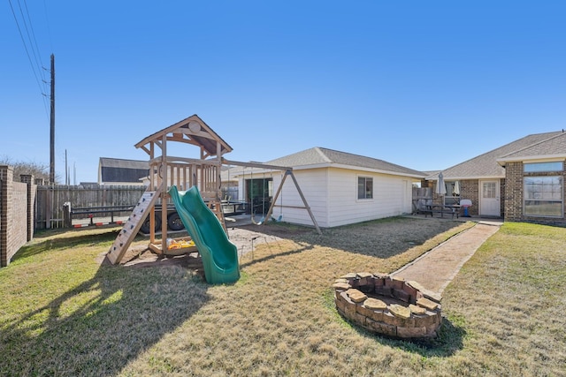 view of play area featuring a yard and a fire pit