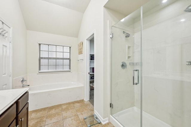 bathroom featuring vanity, vaulted ceiling, tile patterned floors, and separate shower and tub